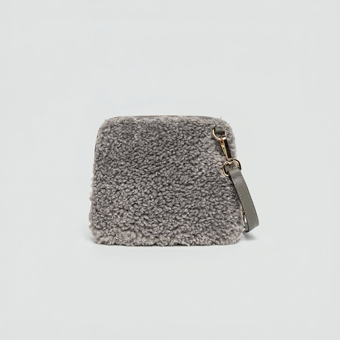 Zita faux shearling crossbody bag in chocolate brown on a light grey studio background