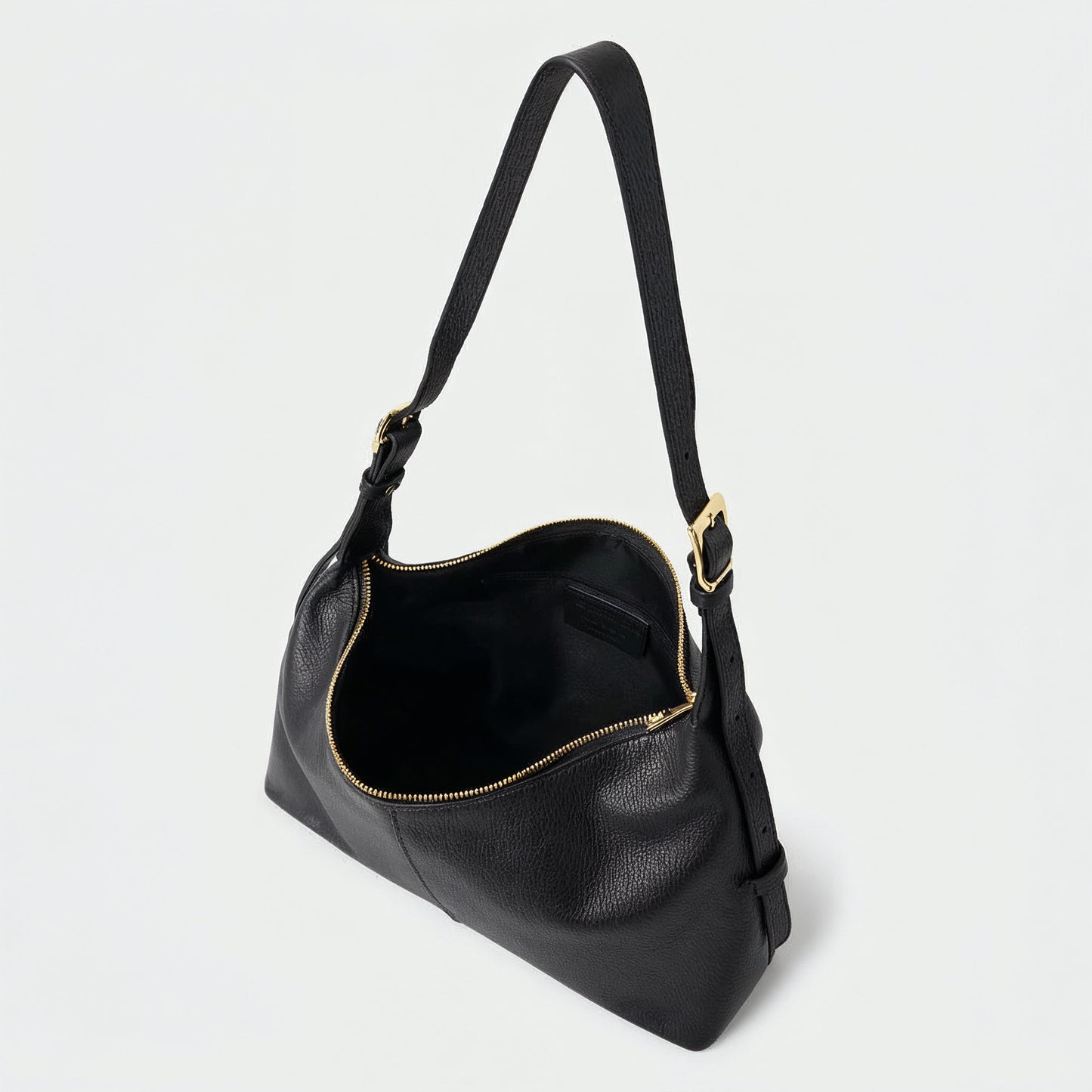 Elettra leather shoulder bag in black on a light grey studio background