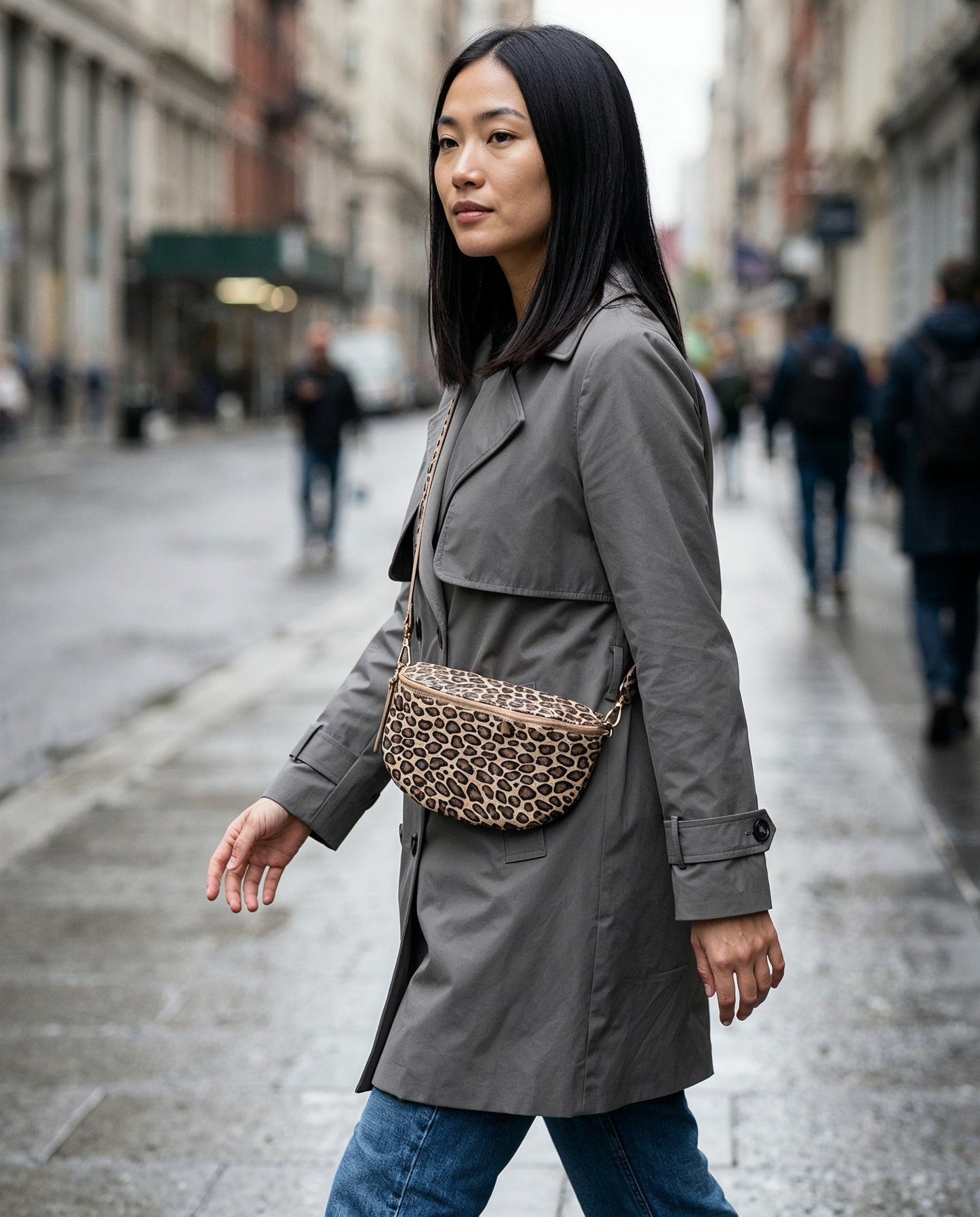 Woman wearing the Matt Light Taupe Leopard Romy bum bag on an overcast city street