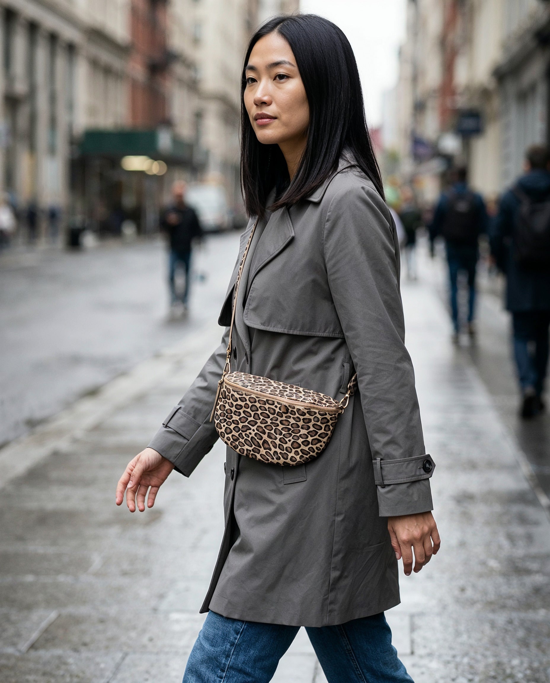 Woman wearing the Matt Light Taupe Leopard Romy bum bag on an overcast city street