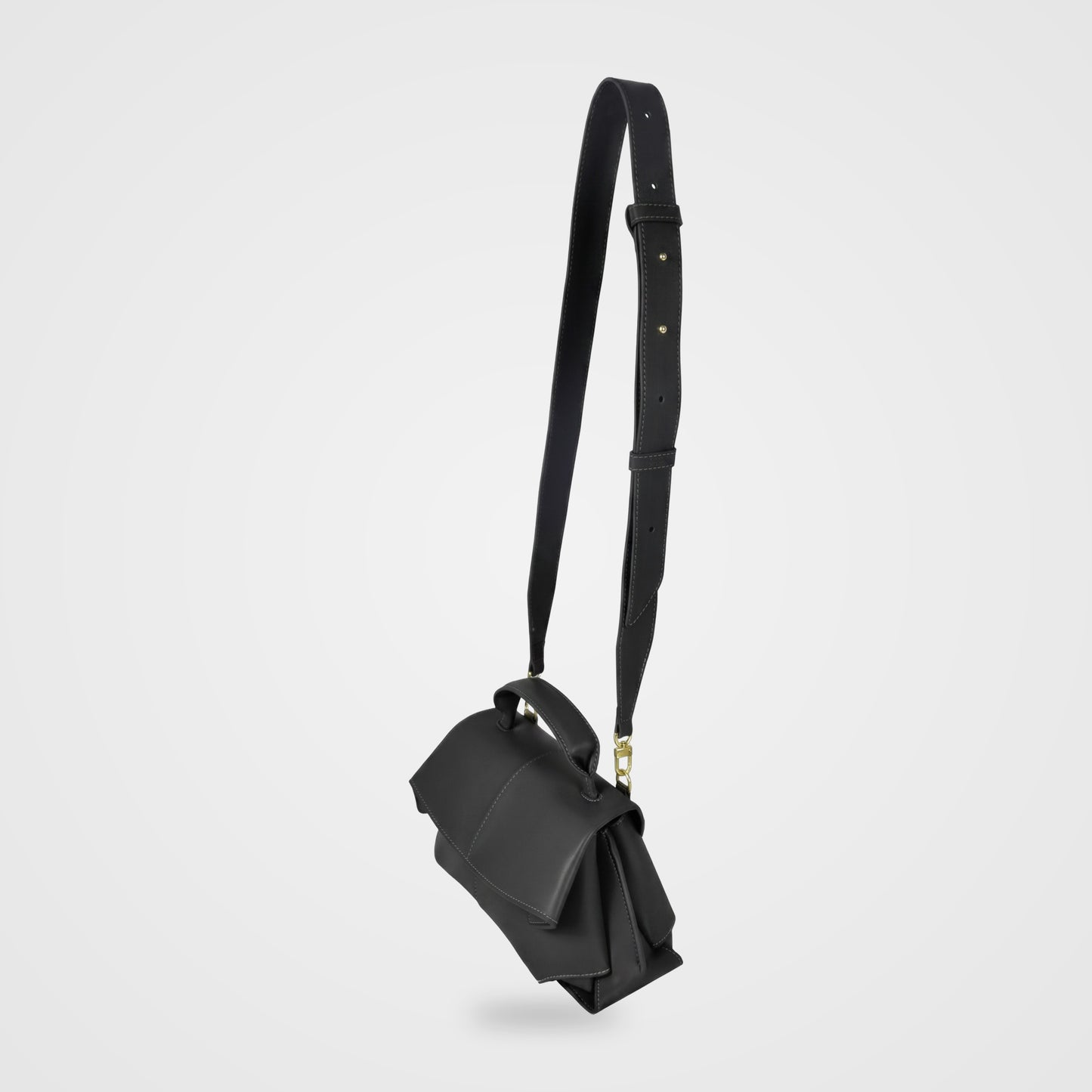 Fiorella bag in Black hanging from its long adjustable shoulder strap