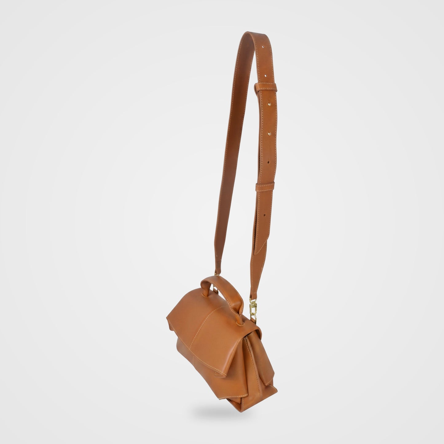 Fiorella bag in Cognac hanging from its long adjustable shoulder strap