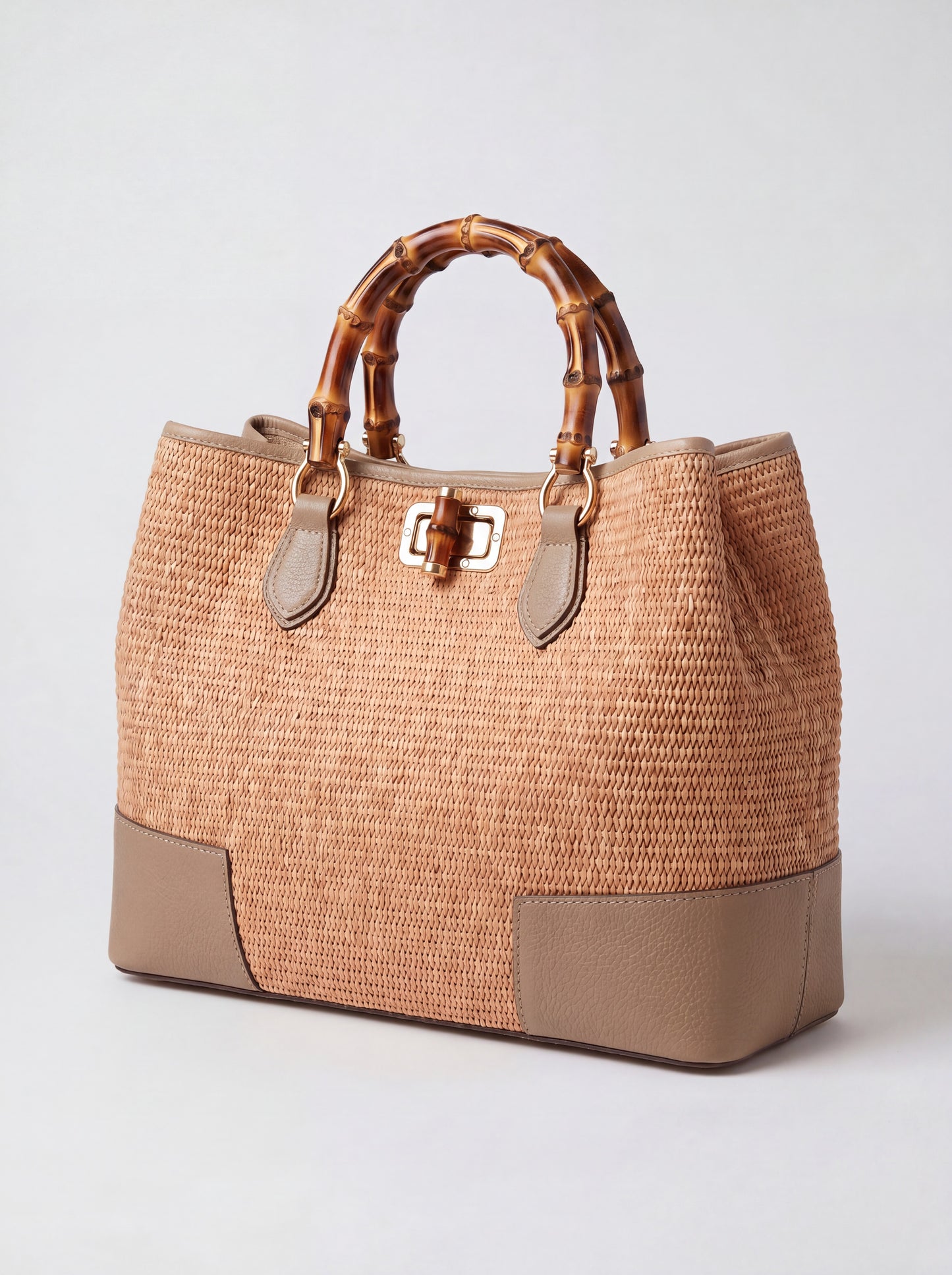 Ginevra Bamboo-Handle Raffia Bag by Clemés in Light Taupe, three-quarter studio shot on grey background