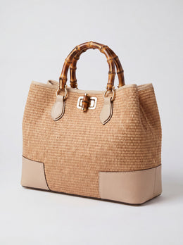 Ginevra Bamboo-Handle Raffia Bag by Clemés in Oyster, three-quarter studio shot on grey background