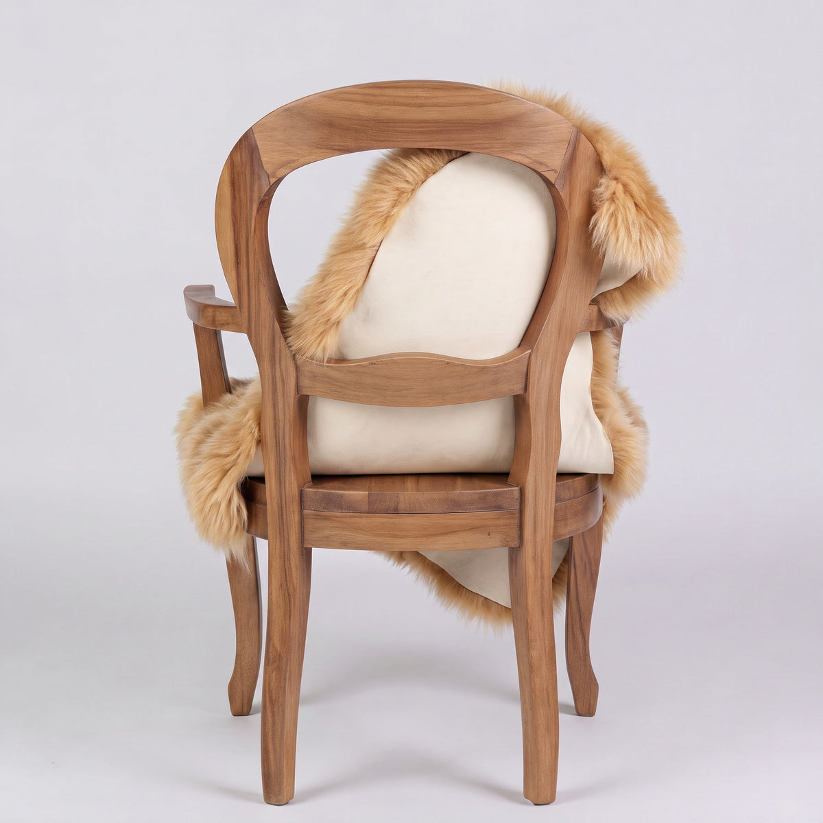 Honey sheepskin rug over the back of a chair showing the cream suede underside