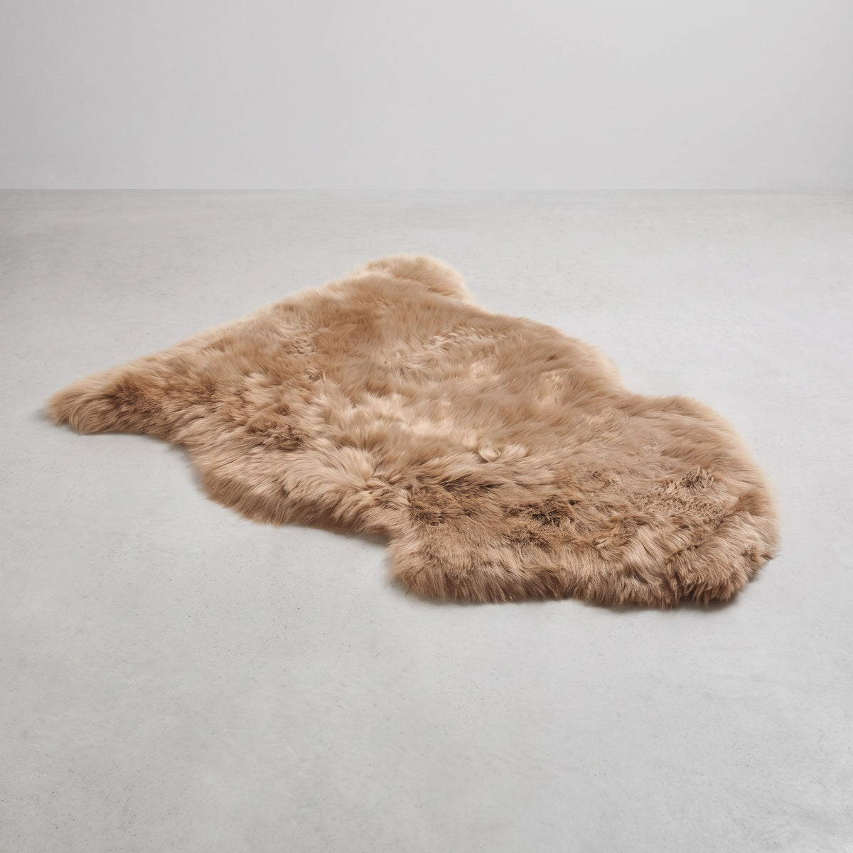 Honey single sheepskin rug flat on a pale grey floor