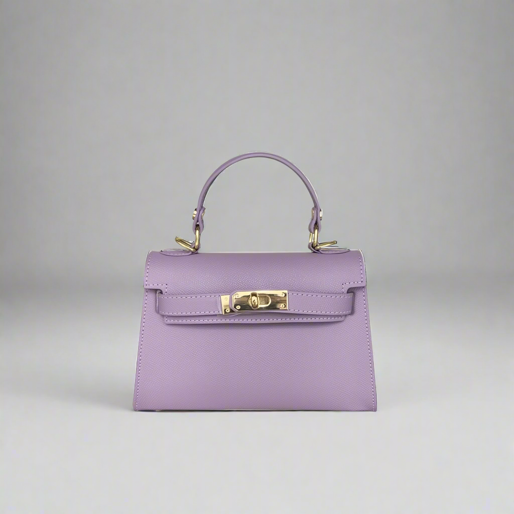 Purple handbag with gold hardware on a white background