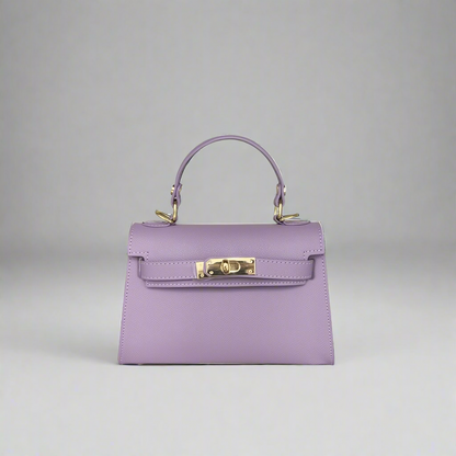 Purple handbag with gold hardware on a white background