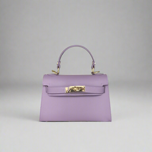 Purple handbag with gold hardware on a white background