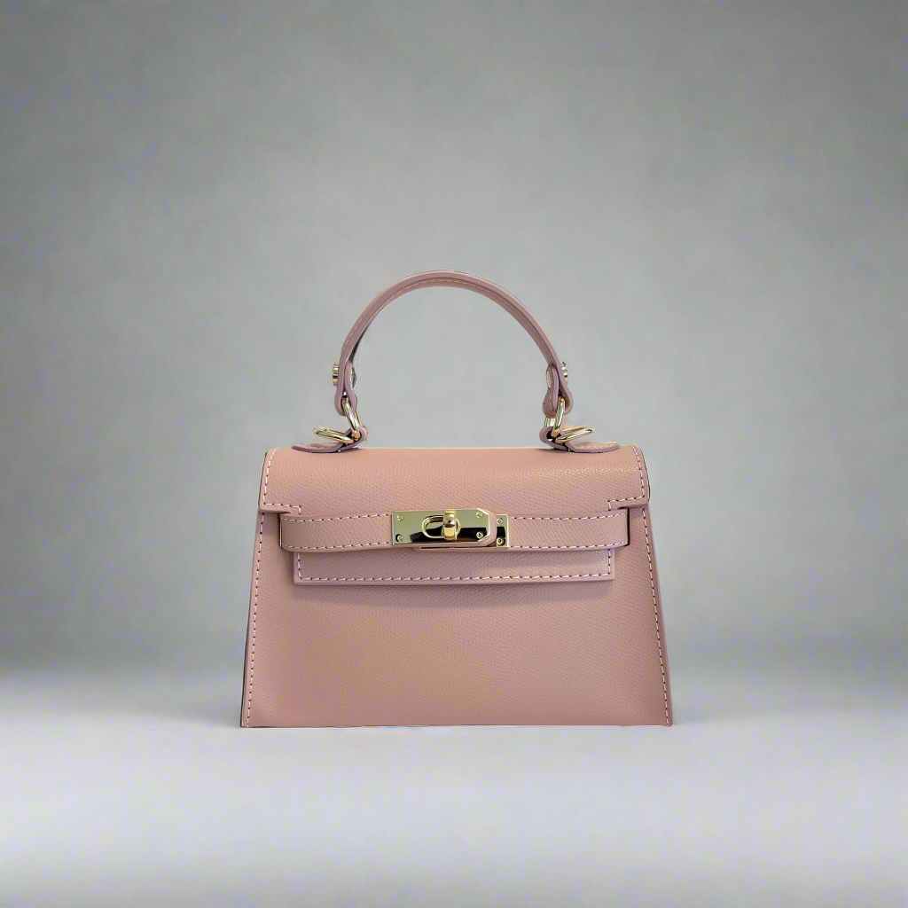 The Mini Kelly-Inspired Epsom Leather Handbag by Clemés in Rose, three-quarter studio shot on grey background