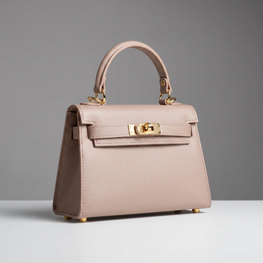 The Mini Kelly-Inspired Epsom Leather Handbag by Clemés in Dusty Rose, three-quarter studio shot on grey background