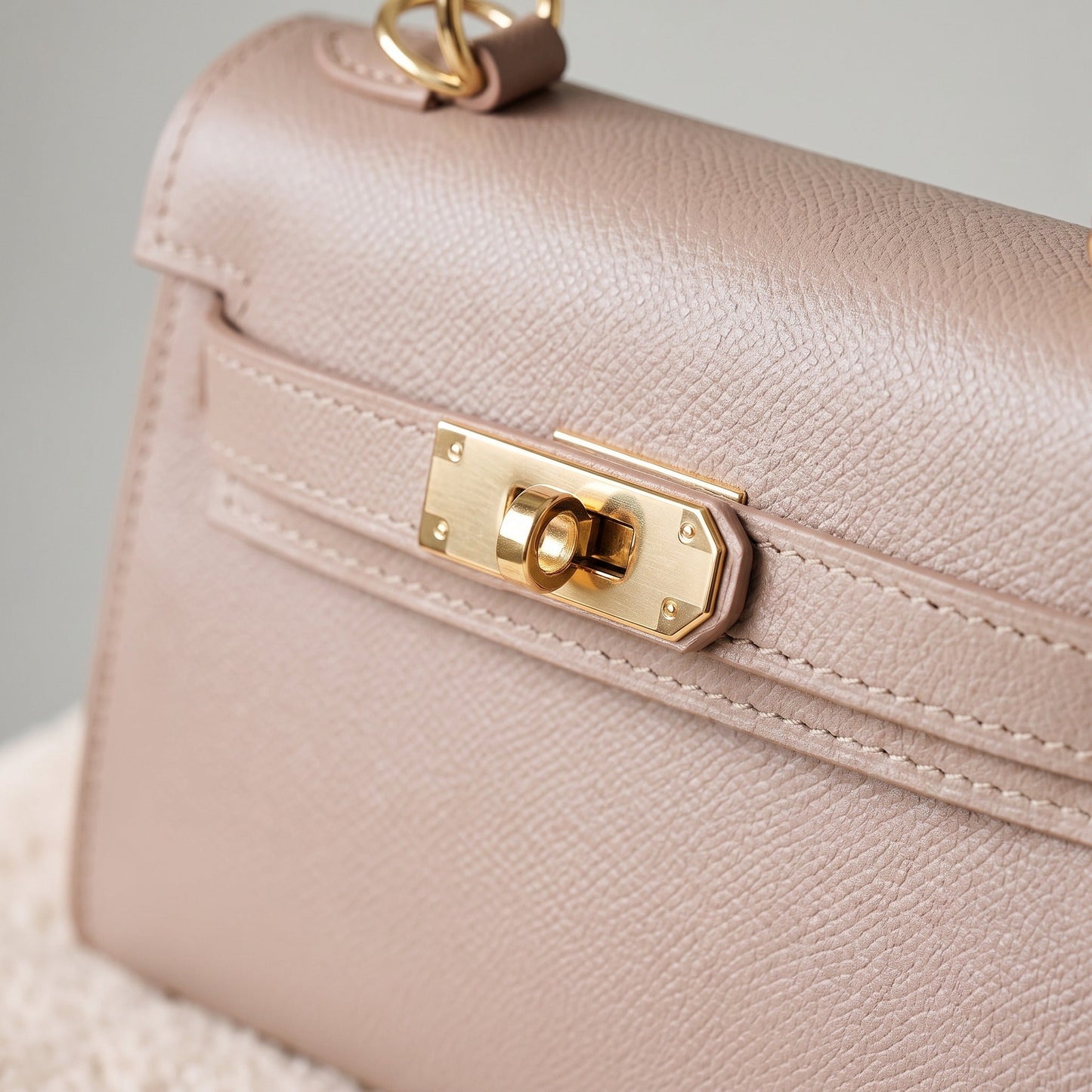 Gold-tone turn-lock clasp and Epsom grain detail on the Dusty Rose Mini Kelly-Inspired handbag by Clemés