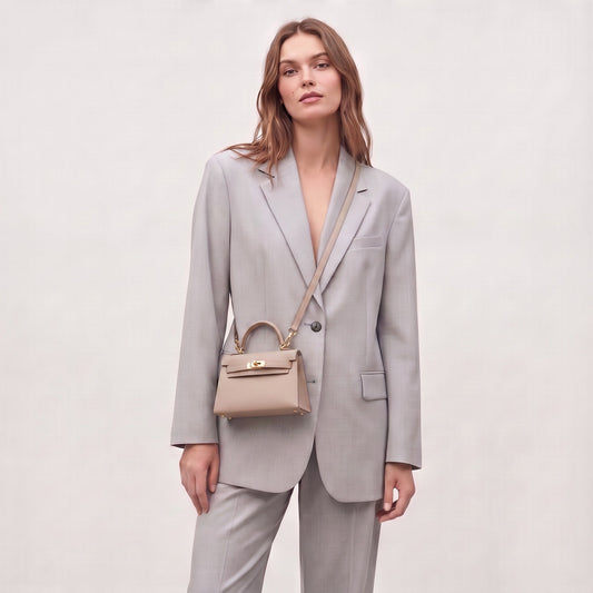 Model carrying the Dusty Rose Mini Kelly-Inspired handbag by Clemés, full-length studio shot