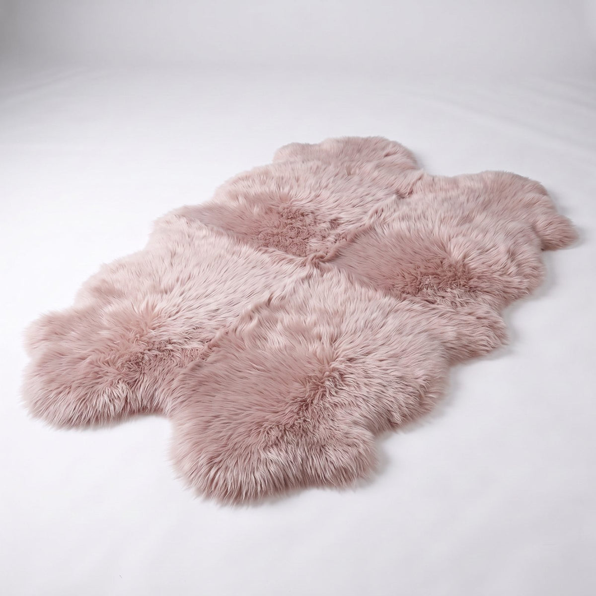 Light Rose quad sheepskin rug, four soft dusty rose pink skins stitched together, studio shot