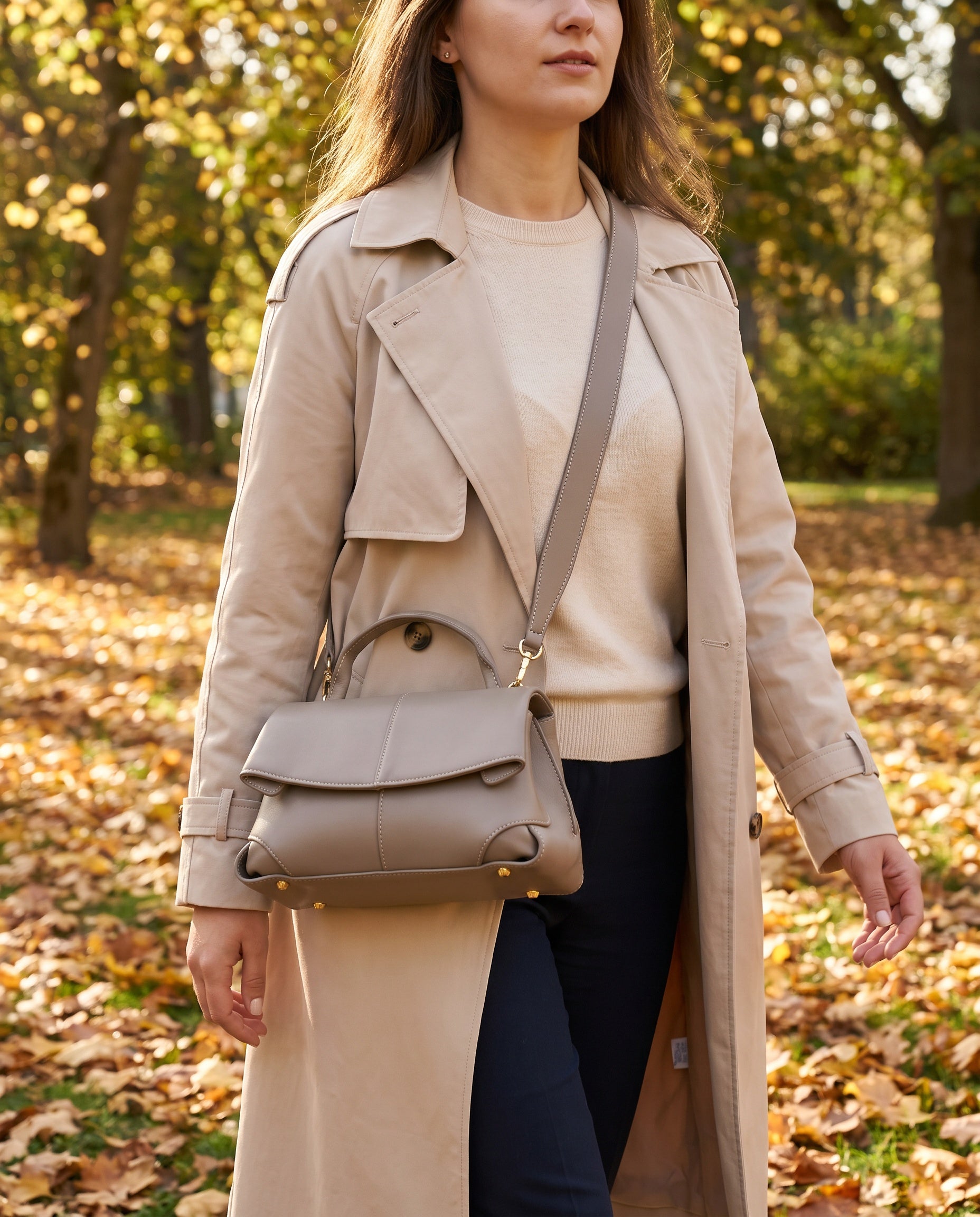Woman with the Taupe Fiorella bag on her shoulder in an autumn park