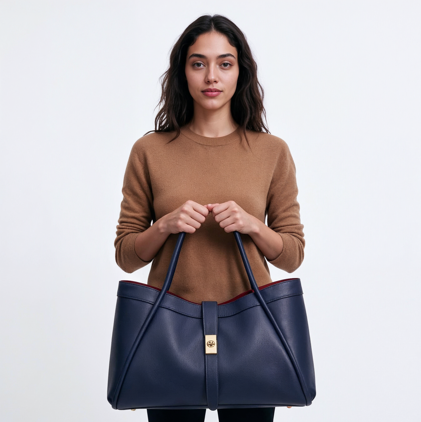 Woman holding the Navy Bianca Large tote by its two handles