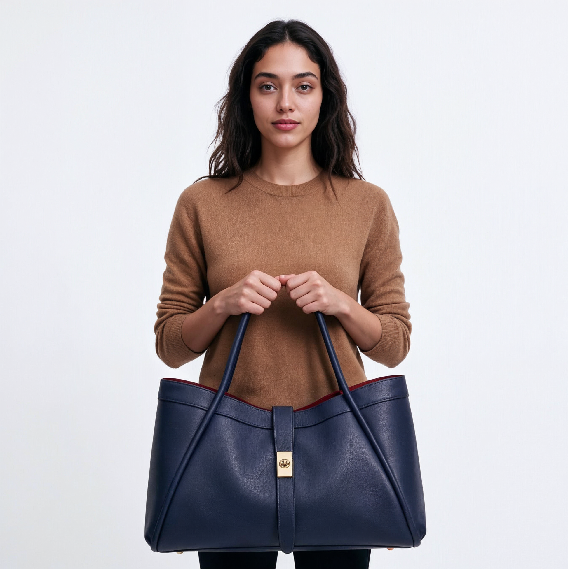 Woman holding the Navy Bianca Large tote by its two handles