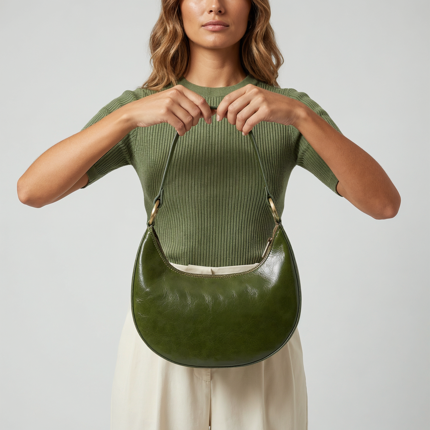 Model holding the Dark Olive Mezzaluna bag against her torso