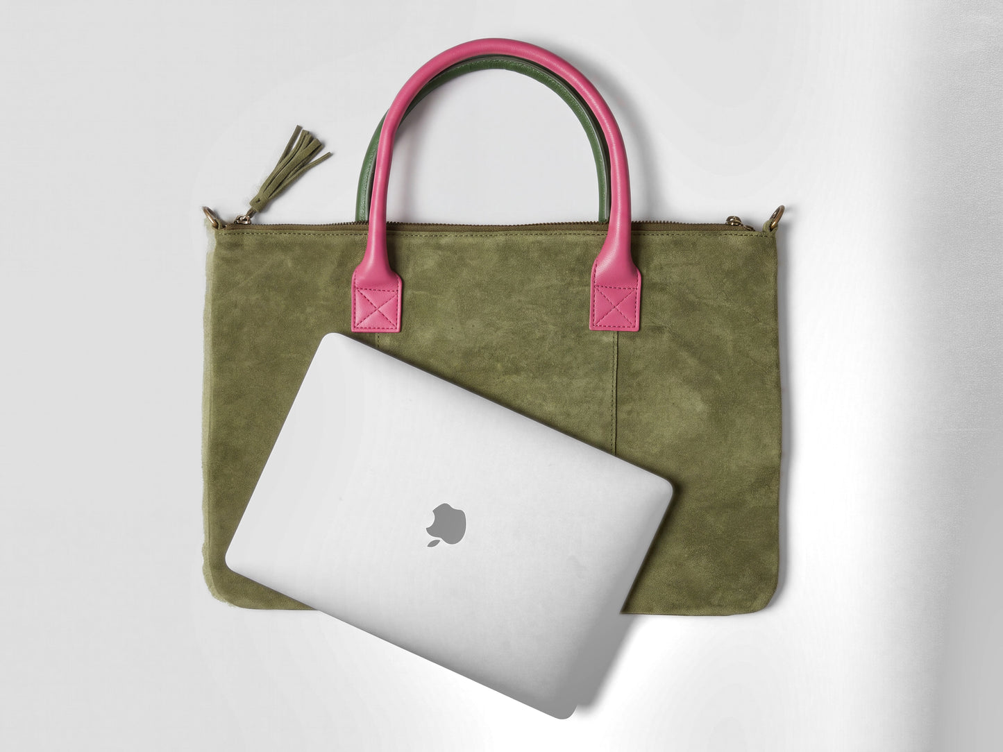 Size comparison: the smaller regular Milano suede bag in olive shown with a 13-inch laptop overhanging it, next to the larger Milano Max