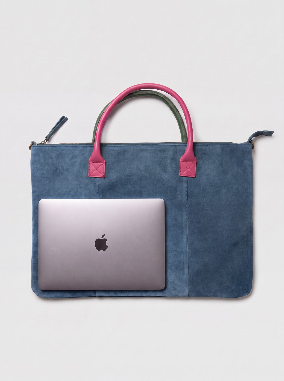 Milano Max Suede Bag in Blue by Clemés, flat overhead studio shot with a 13-inch MacBook on the bag showing how much it holds