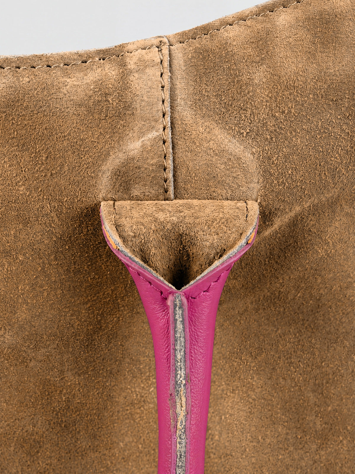 Milano Max Suede Bag in Tan by Clemés, macro detail of the tan suede gusset where the pink handle is anchored