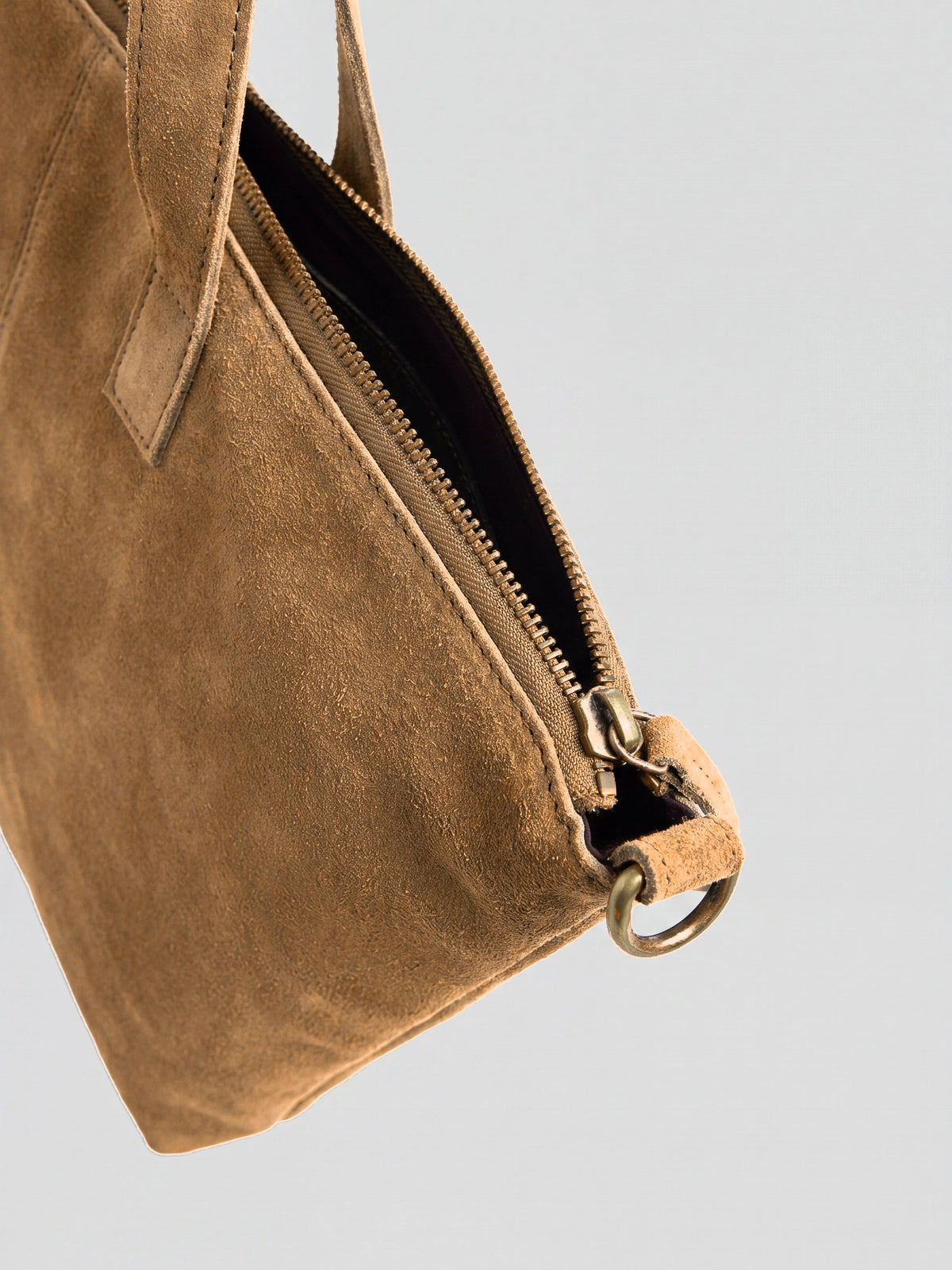 Milano Max Suede Bag in Tan by Clemés, close-up of the zip end with antique brass slider and D-ring on the tan suede tab