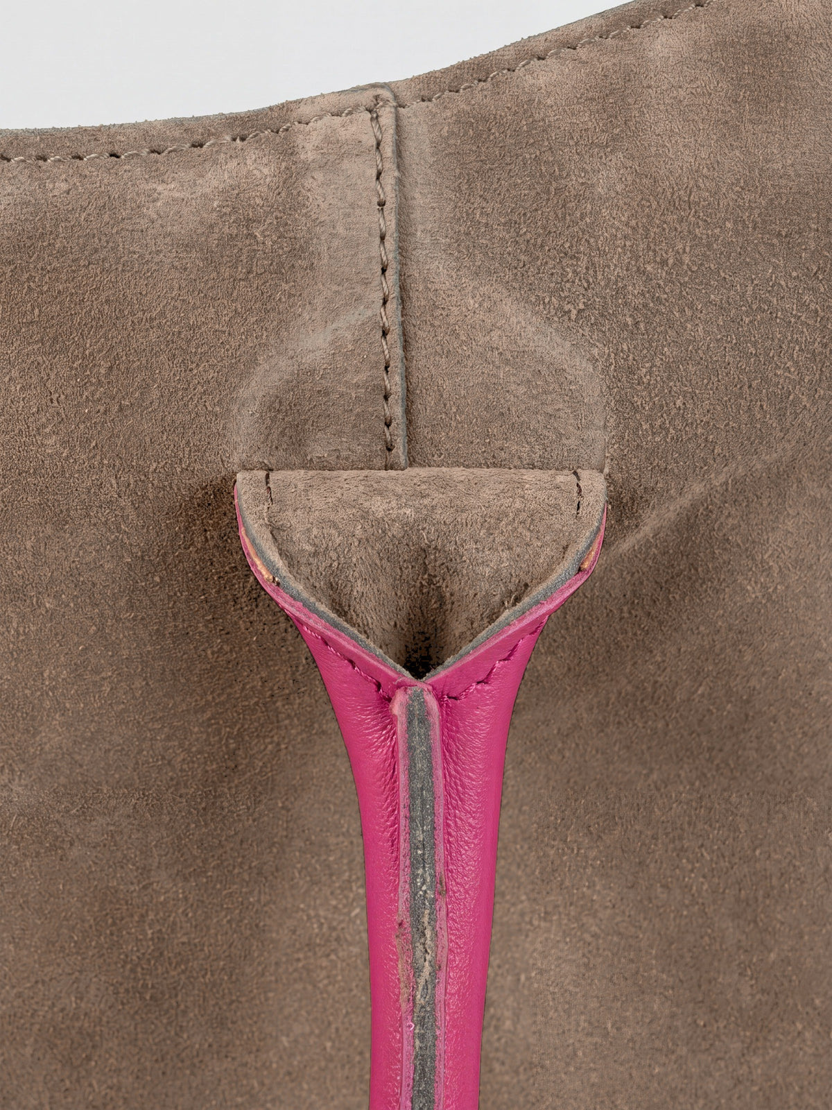 Milano Max Suede Bag in Taupe by Clemés, macro detail of the taupe suede gusset where the pink handle is anchored