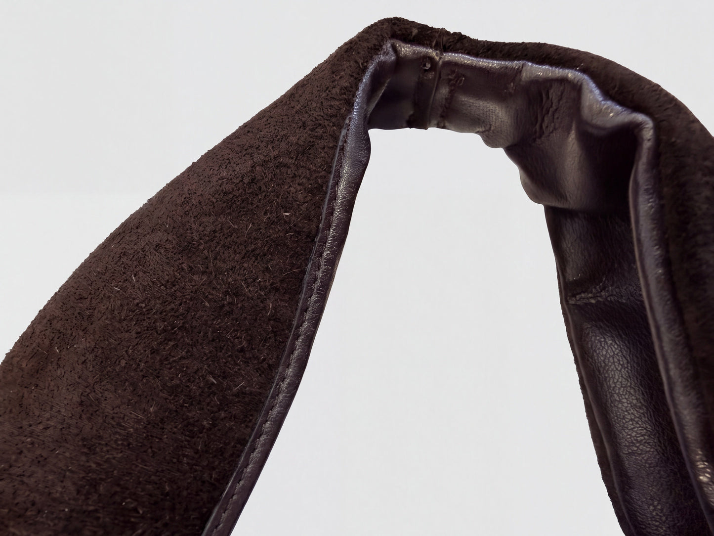 Close-up of the leather-bound top edge and suede nap on the Dark Brown Noemi Suede Handbag