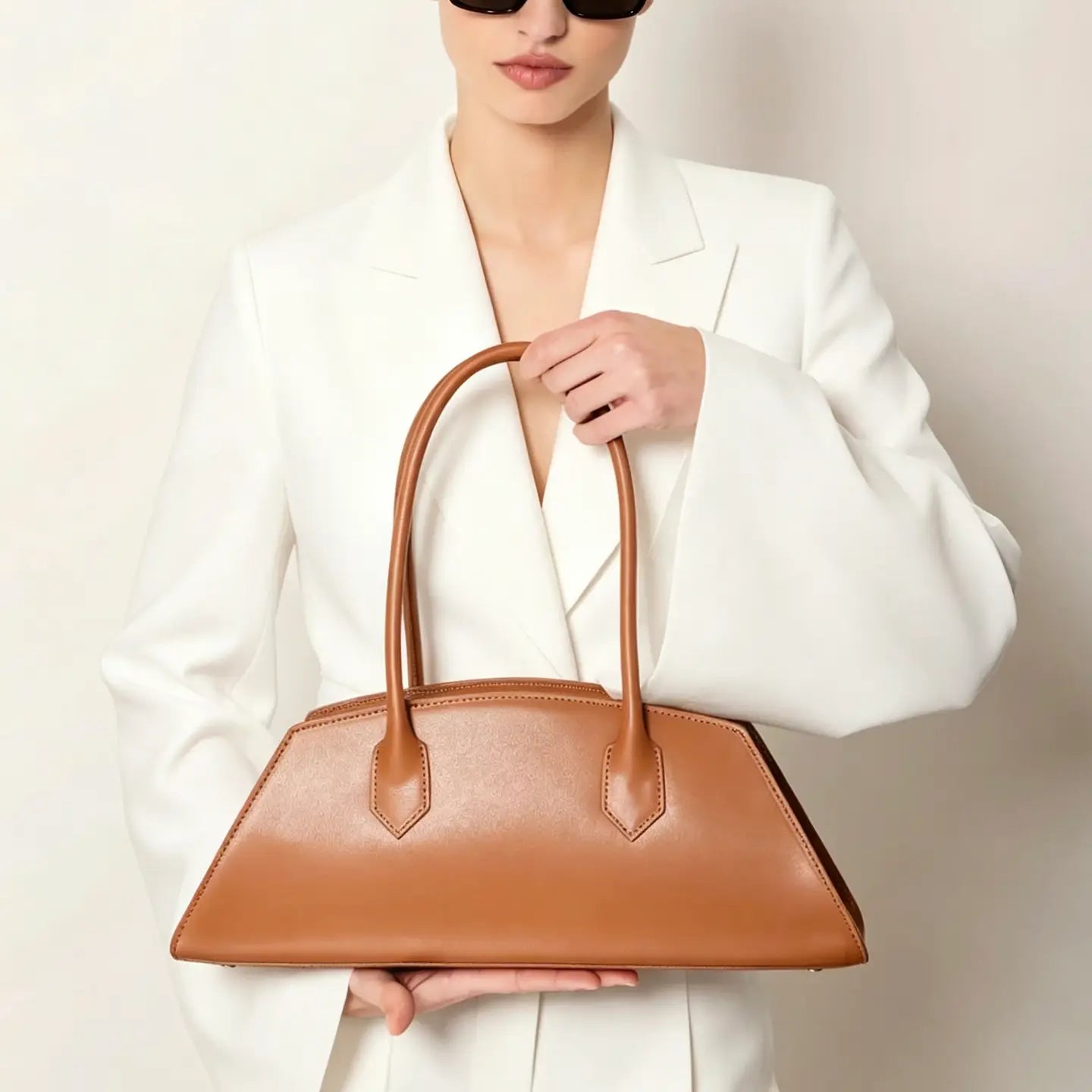 Model carrying the Nora Calfskin Shoulder Bag by Clemés in Cognac