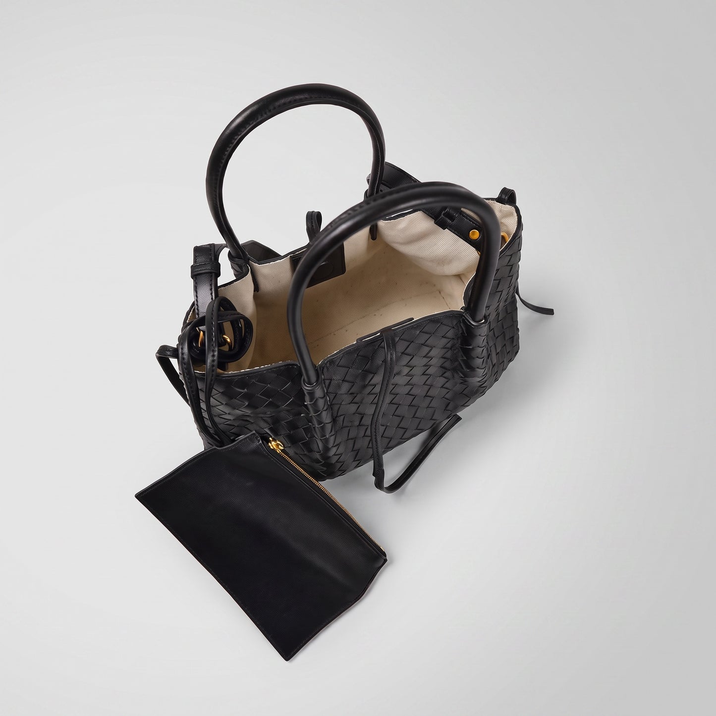 Ornella woven leather bag open at a high angle showing lining and coin purse