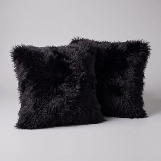 Pair of Black double-sided New Zealand sheepskin cushion covers, 35 x 35 cm, side by side