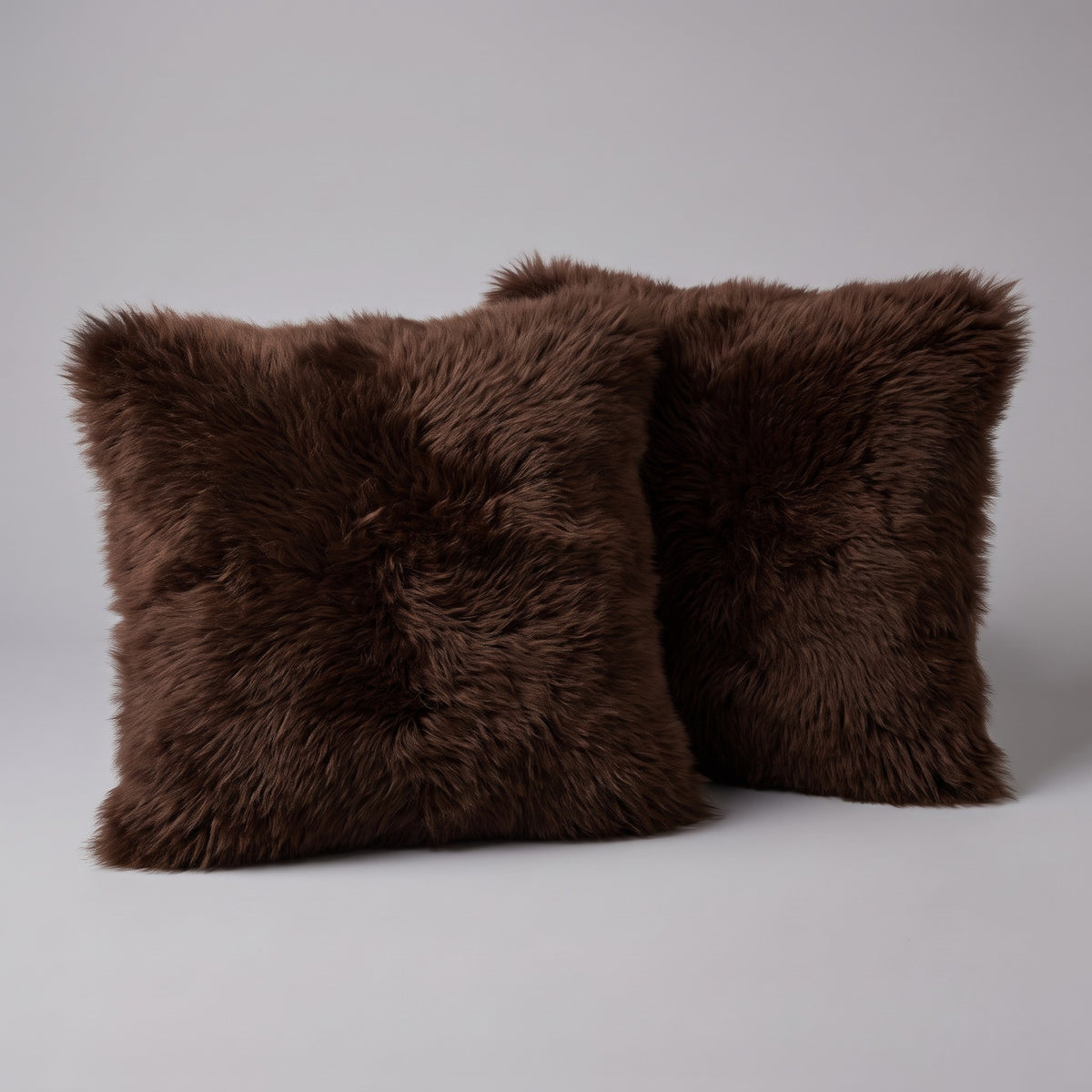Pair of Dark Chocolate double-sided New Zealand sheepskin cushion covers, 35 x 35 cm, side by side