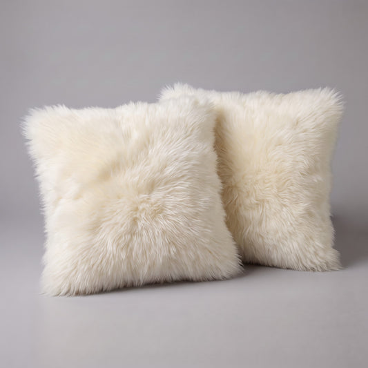 Pair of Ivory double-sided New Zealand sheepskin cushion covers, 35 x 35 cm, side by side