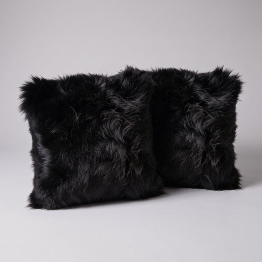 Pair of Black New Zealand sheepskin cushion covers, 35 x 35 cm, side by side