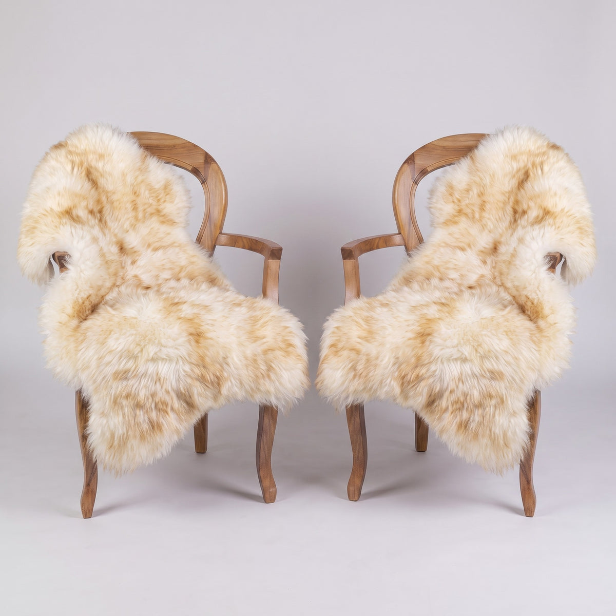 Pair of Dusk X-Large single sheepskin rugs draped over two armchairs