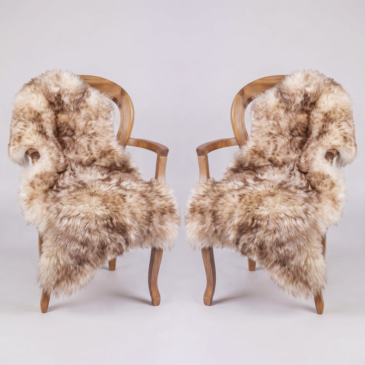 Pair of Eclipse X-Large single sheepskin rugs draped over two armchairs