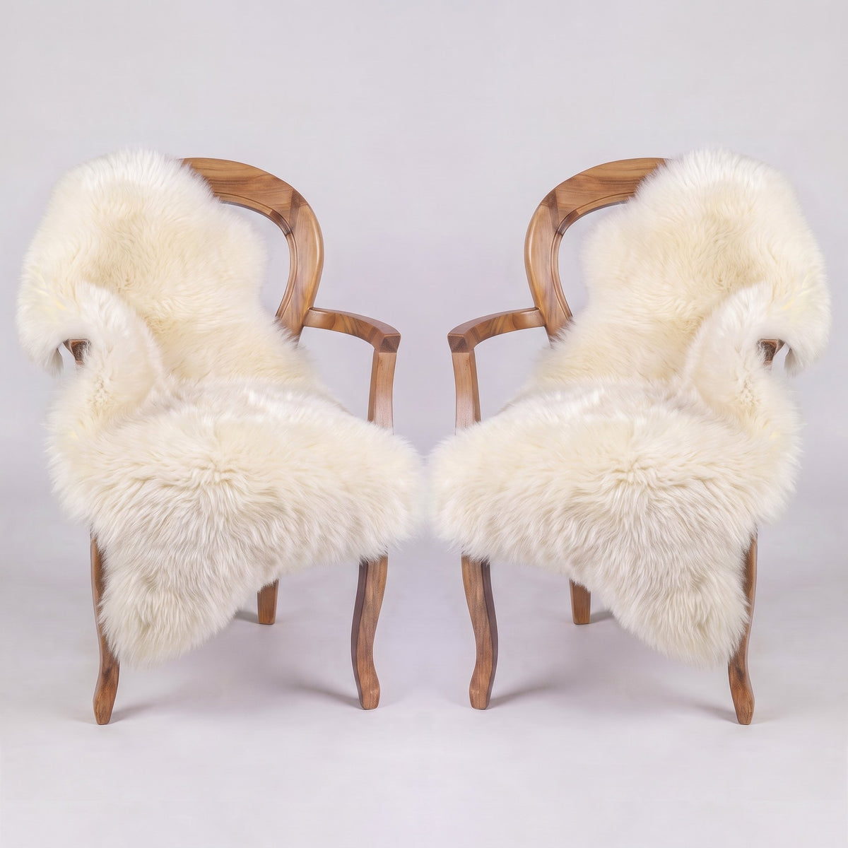 Pair of Ivory X-Large single sheepskin rugs draped over two armchairs