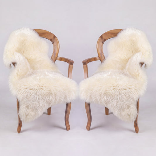 Pair of Ivory X-Large single sheepskin rugs draped over two armchairs