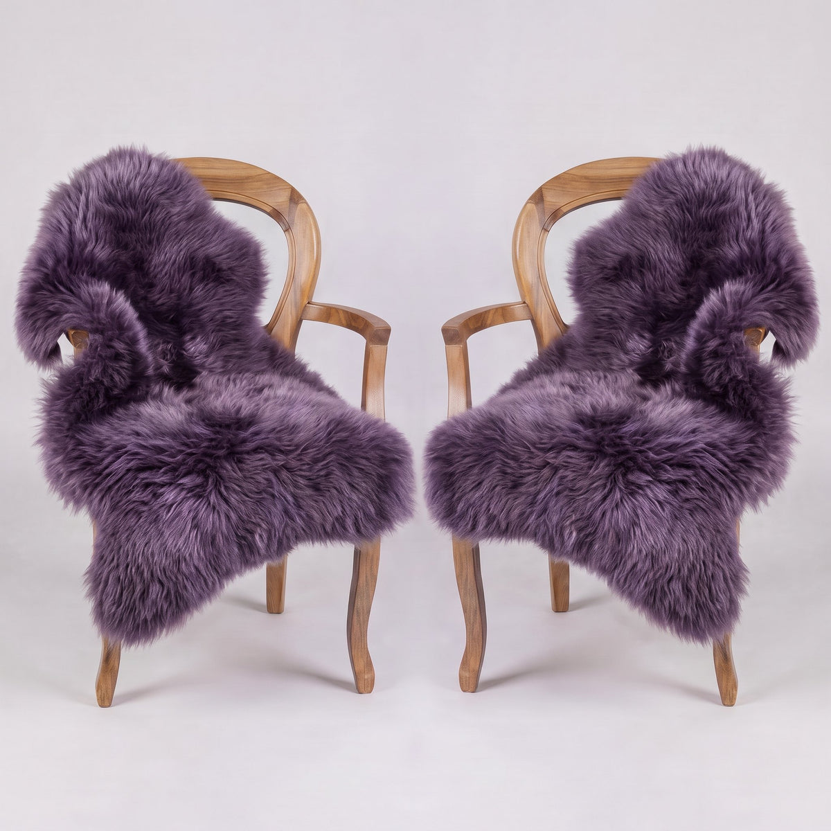 Pair of Purple X-Large single sheepskin rugs draped over two armchairs