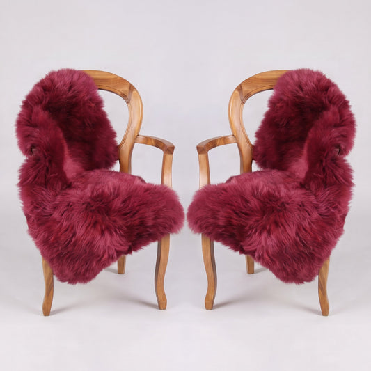 Pair of Raspberry X-Large single sheepskin rugs draped over two armchairs