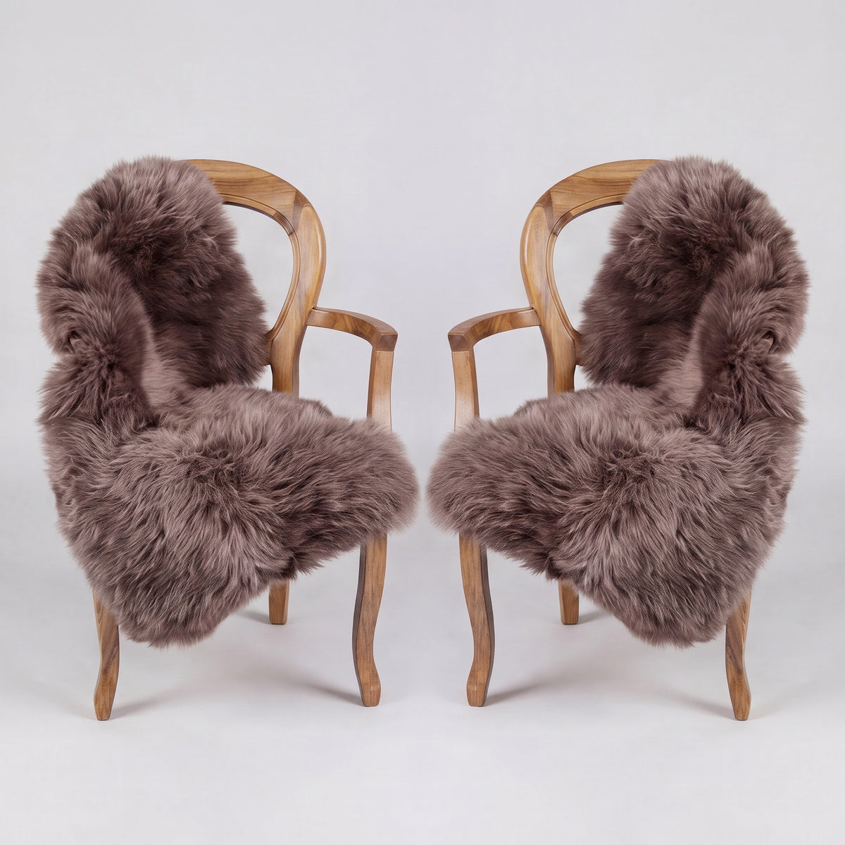Pair of Taupe X-Large single sheepskin rugs draped over two armchairs