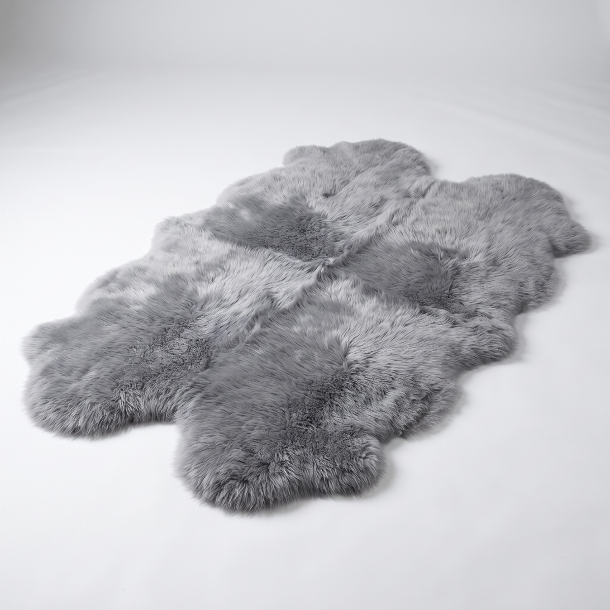 Quad New Zealand Sheepskin Rug & Throw in Grey Mist, studio shot