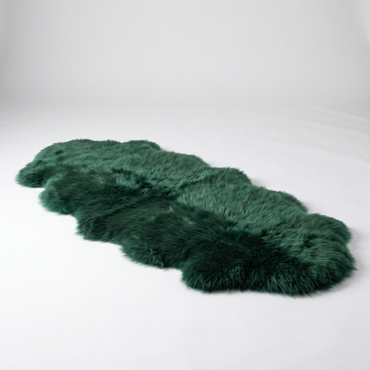 Quad New Zealand Sheepskin Rug & Throw in Jungle Green, studio shot