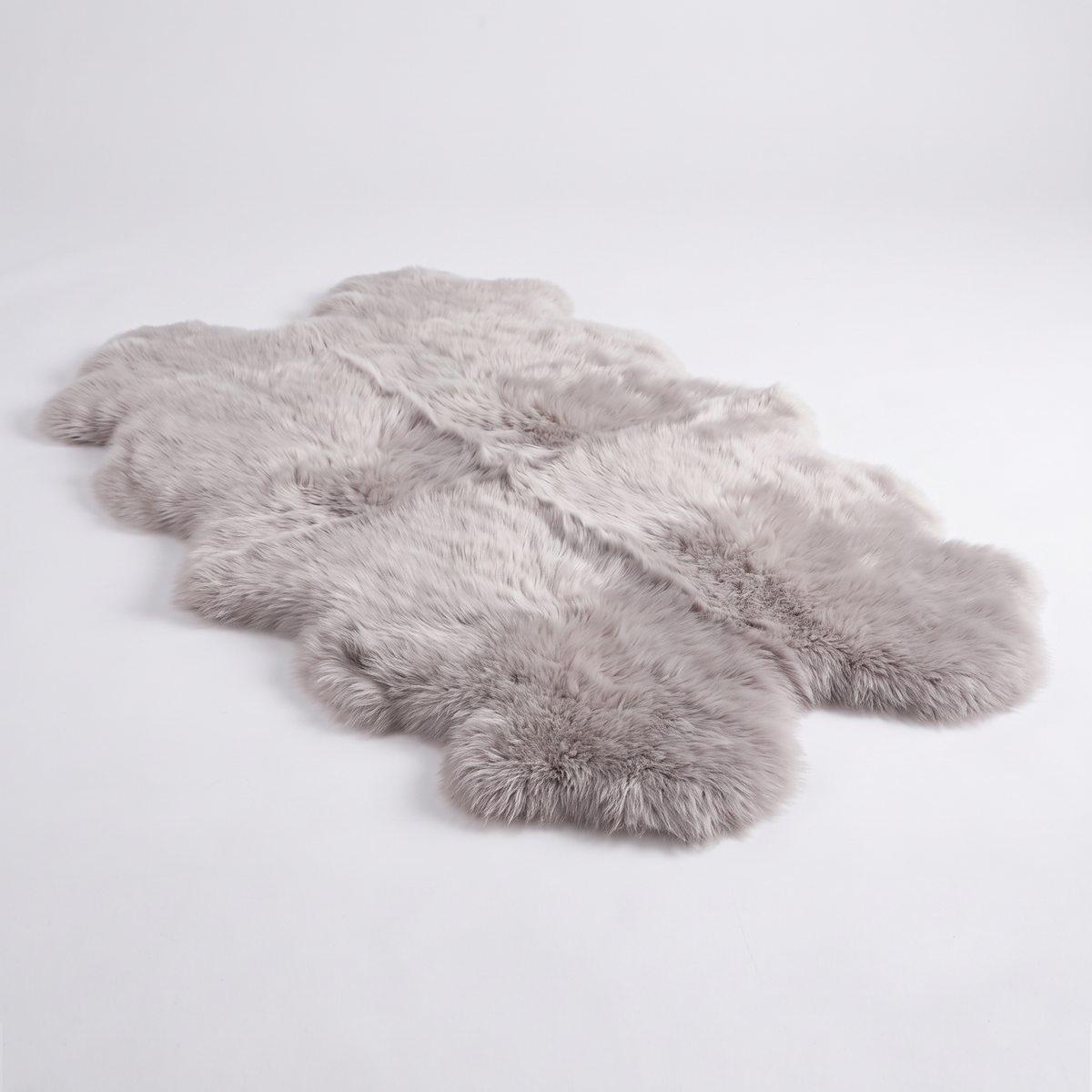 Quad New Zealand Sheepskin Rug & Throw in Light Grey, studio shot
