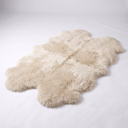 Linen quad New Zealand sheepskin rug, four very light cream pelts stitched together, studio shot