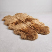 Honey quad New Zealand sheepskin rug, four pelts, L180 x W105 cm, on a pale grey studio floor