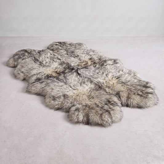 Twilight quad New Zealand sheepskin rug, cream wool with charcoal-grey tipping, L180 x W105 cm, on a pale grey studio floor