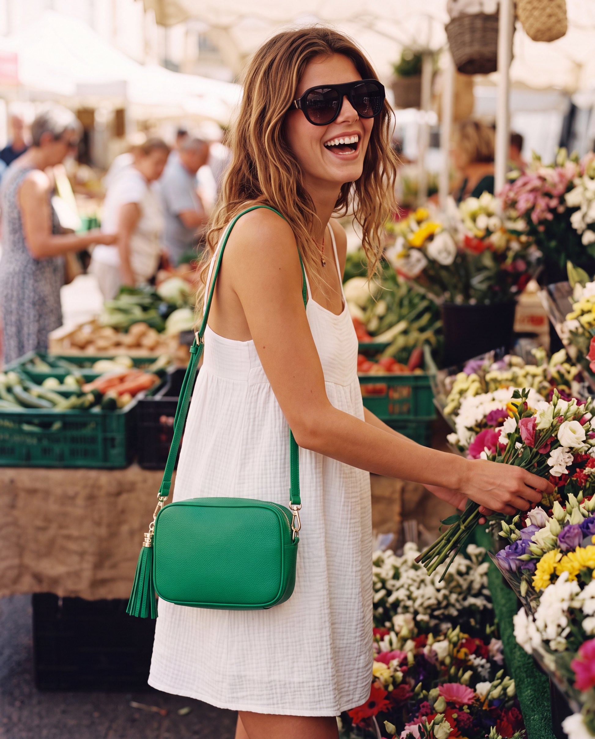 Model with the Green Éloise Leather Tassel Camera Bag by Clemés at a sunny farmers' market