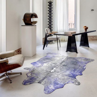 Violet and Grey metallic cowhide rug styled on the pale stone floor of a bright minimalist study