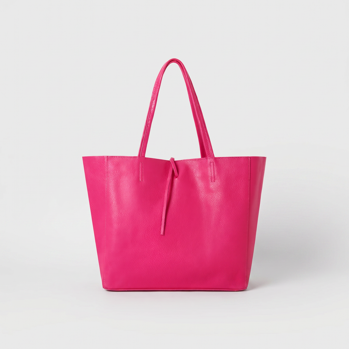 Carlotta Oversized Leather Tote in Fuchsia on light grey studio background
